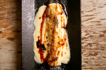 Meat cannelloni. Traditional Christmas recipe in Barcelona. Pasta cylinders stuffed with meat au gratin with cheese.