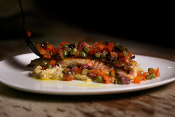 Baked turbot with roasted vegetables. Traditional recipe from the basque country in the north of...