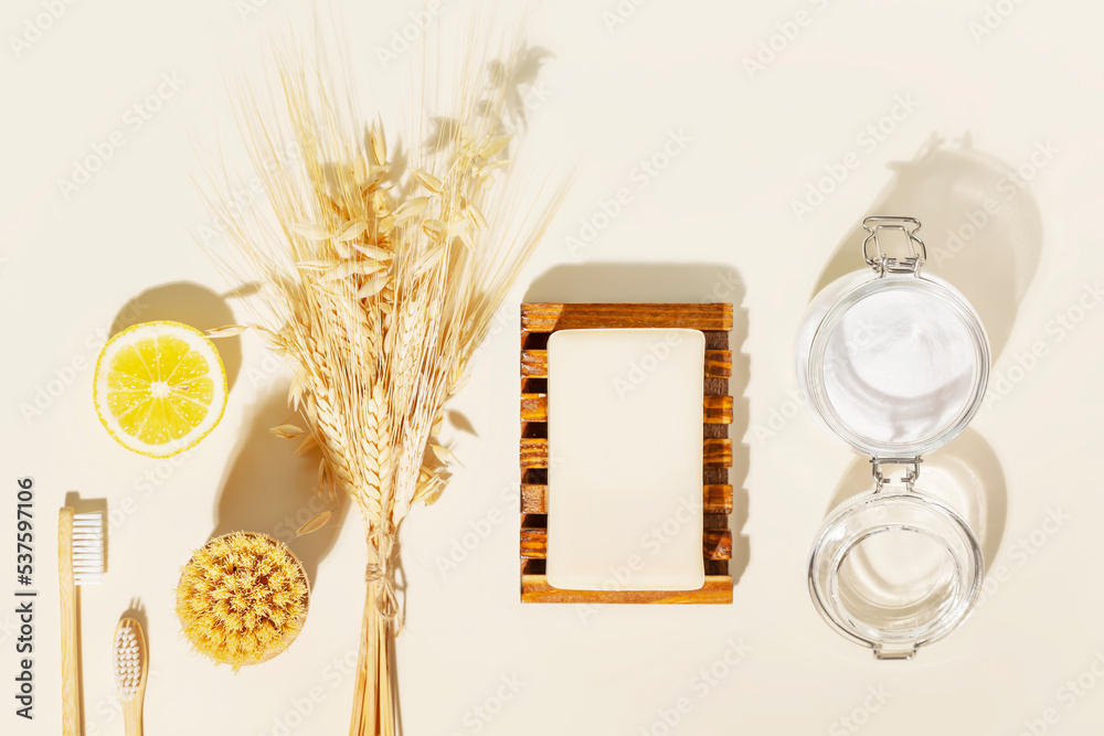 Sticker Eco friendly flat lay with natural cleaning products: organic soap, soda, lemon, wooden brushes and bouquet of rye and wheat on a light background. Various items and ingredients for eco home cleaning