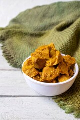 Jackfruit Gravy or Curry in a White Bowl on Burlap Fabric Isolated on White Wooden Background