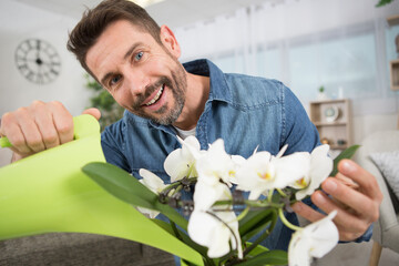 young bearded hipster sman holding flowers