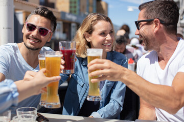 friends drinking beer and having fun outdoors
