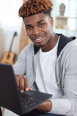 young man relaxing on the sofa with a laptop