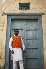 boy wearing old clothes infront of vintage building