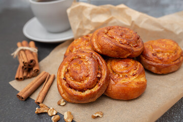 Sweet rolls with cinnamon on wooden board. Caramel buns with nuts.