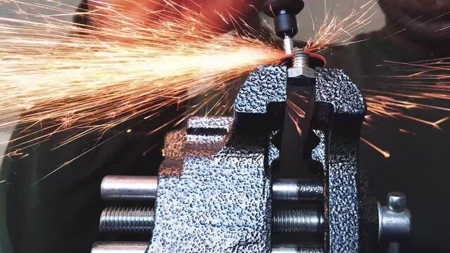 Cutting Bolt With Rotary Tool With Sparks Flying Around