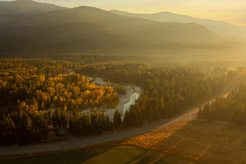 Misty Fall Morning Over the Methow River Near Mazama, Washington. Aerial drone view at sunrise of...