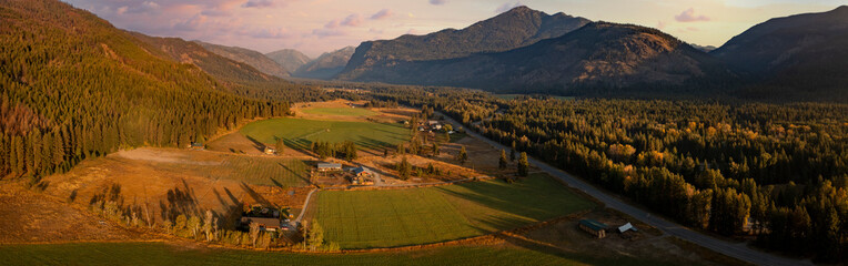 Aerial Panoramic View of the Historic Methow Valley in Eastern Washington State. Farm and ranch land lead to the North Cascade Mountains in this stunning landscape photographed on an autumnal morning. - obrazy, fototapety, plakaty