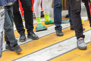 Fototapeta premium Many different, strange persons on a pedestrian crossing, crowd of people crossing a street