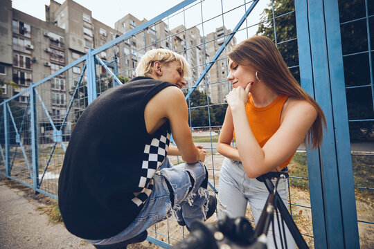 Teenage Couple Hanging Out Outside With A Bicycle.