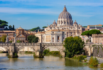 Fototapeta na wymiar St Peter's basilica in Vatican and St. Angel bridge over Tiber river in Rome, Italy