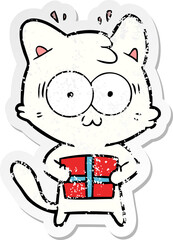 distressed sticker of a cartoon surprised cat with christmas present