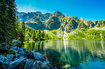 Tatra National Park in Poland. Famous mountains lake Morskie oko or sea eye lake In High Tatras. Five lakes valley - obrazy, fototapety, plakaty