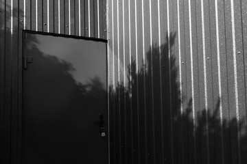 Black and white photo of metal door of metal barnhouse.
