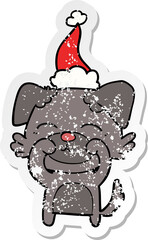hand drawn distressed sticker cartoon of a dog wearing santa hat