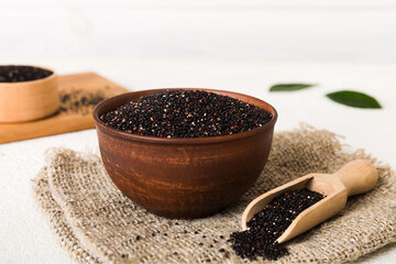 quinoa seeds in bowl and spoon on colored background. Healthy kinwa in small bowl. Healthy superfood