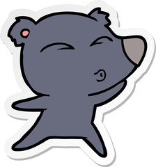 sticker of a cartoon whistling bear