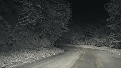 Mountain forest slippery road on a winter night
