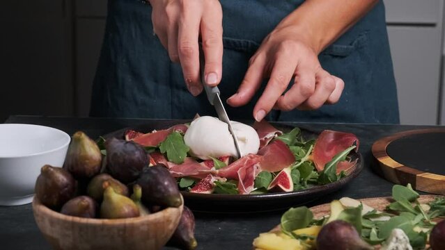 women's hands make fresh salad