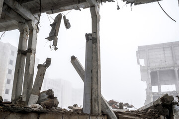 The destroyed big concrete building in a foggy haze. Background.