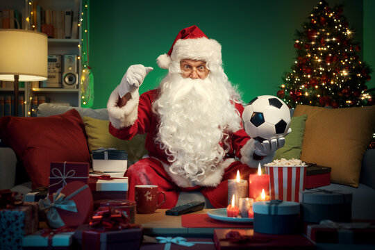 Happy Santa Claus Watching Soccer On TV