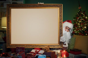Santa Claus holding a big framed picture