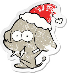 happy hand drawn distressed sticker cartoon of a elephant wearing santa hat