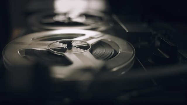Vintage Tape Recorder Roller. Reel film tape is rotating at a vintage professional player. Oldschool concept