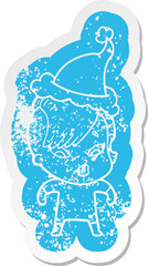 quirky cartoon distressed sticker of a surprised girl wearing santa hat