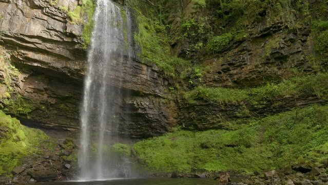Picturesque waterfall, surrounded by foliage in a forest