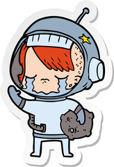 sticker of a cartoon crying astronaut girl carrying rock sample