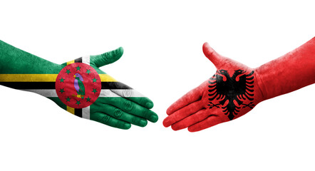 Handshake between Albania and Dominica flags painted on hands, isolated transparent image.