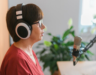 Middle-aged woman radio host making podcast recording for online show - broadcast and dj concept