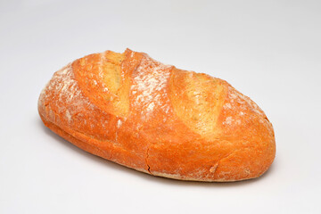 loaf of fresh wheat bread on white background