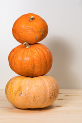 Pyramid of three yellow pumpkins, golden autumn, Halloween concept and autumn harvest of pumpkins