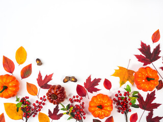 Leaves and pumpkins on a light background, view from above. Design for different purposes.