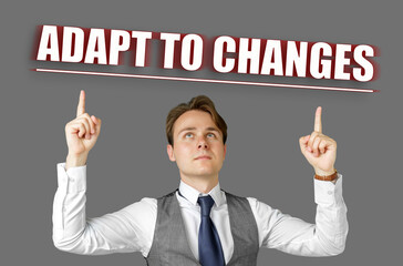 Businessman points fingers at the inscription - Adapt to Changes