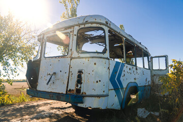 War in Ukraine. 2022 Russian invasion of Ukraine. Countryside. Damaged bus after shelling. Terror of the civilian population. war crime