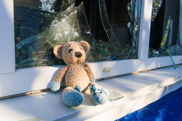 War in Ukraine. 2022 Russian invasion of Ukraine. The toy (teddy bear) lies next to the broken...