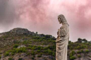 statue of a Christ in Mijas pueblo with mountains skyline in the background