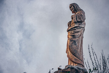 statue of a Christ in Mijas pueblo with mountains skyline in the background