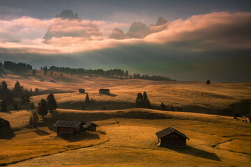 Cloudy sunrise on Seiser Alm meadow in Dolomites