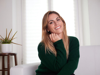 Carefree woman relaxing sitting on a sofa at home