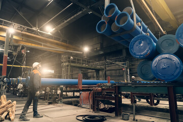 Shipment of metal pipes for gas pipeline or water in factory floor.