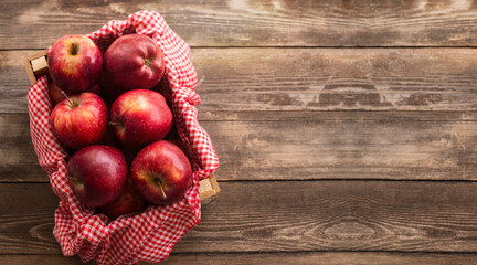 Fresh red apples in wooden box