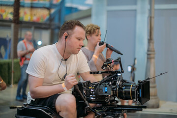 Director of photography with a camera in his hands on the set. Professional videographer at work on filming a movie
