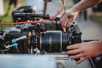 Professional cinema and video camera on the set. Shooting shift, lighting fixtures, shooting equipment and the team.