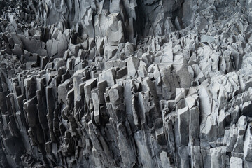 Dramatic rock wall. Textured gray basalt wallpaper background. 