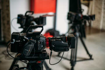 Professional cinema and video camera on the set. Shooting shift, lighting fixtures, shooting equipment and the team.