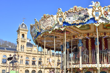 San Sebastian, Spain - 22 Jan, 2022: City hall & merry-go-round on La Concha promenade